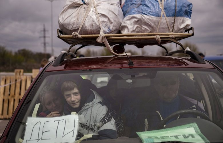 A Ukrainian family arrives in Zaporizhzhia after fleeting Russian-occupied Mariupol in Eastern Ukraine, April 21, 2022. As Russia gained some ground in the east on Thursday, President Joe Biden announced more assistance for Ukraine. (Lynsey Addario/The New York Times) — NO SALES XNYT62 XNYT62