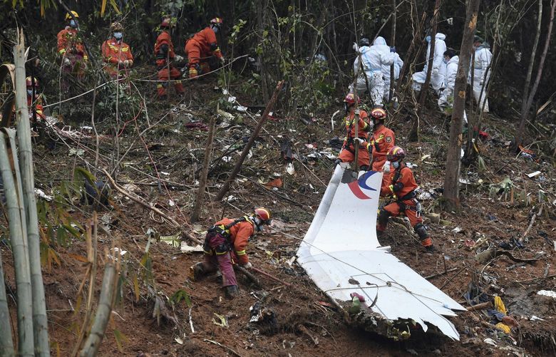 FILE – In this photo released by Xinhua News Agency, search and rescue workers search through debris at the China Eastern flight crash site in Tengxian County in southern China’s Guangxi Zhuang Autonomous Region on Thursday, March 24, 2022. Chinese officials said Thursday that the search for wreckage in last week’s crash of a China Eastern Boeing 737-800 is basically done and that more than 49,000 pieces of debris had been found. (Lu Boan/Xinhua via AP, File) BKWS303 BKWS303