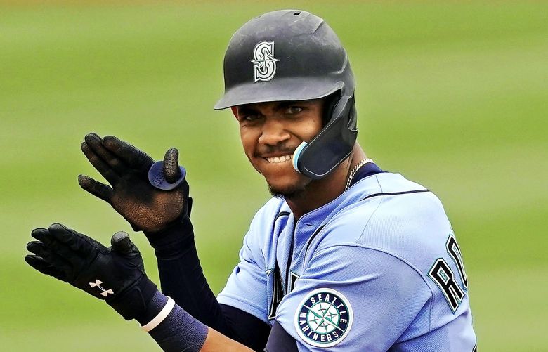 Seattle Mariners’ Julio Rodriguez celebrates on second after hitting a RBI double during the fifth inning of a spring-training baseball game against the Texas Rangers Monday, March 28, 2022, in Peoria, Ariz. (AP Photo/Charlie Riedel)