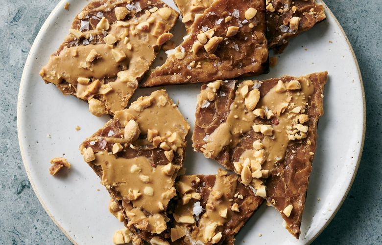 Salted peanut and caramel matzo brittle in New York, March 29, 2022. An adaptation of a popular chocolate matzo toffee, this recipe pairs salted peanut and caramel for a sweet-salty crunch. Food styled by Simon Andrews. (David Malosh/The New York Times)