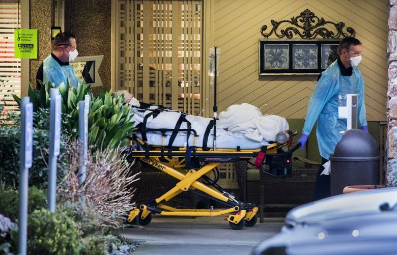 Thursday, March 5, 2020.    Ambulance personel wheel out one of the residents of the Life Care Center in Kirkland taking them to the hospital.  213246