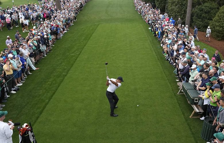 Tiger Woods tees off on the 18th hole during a practice round for the Masters golf tournament on Wednesday, April 6, 2022, in Augusta, Ga. (AP Photo/David J. Phillip) AUG183 AUG183