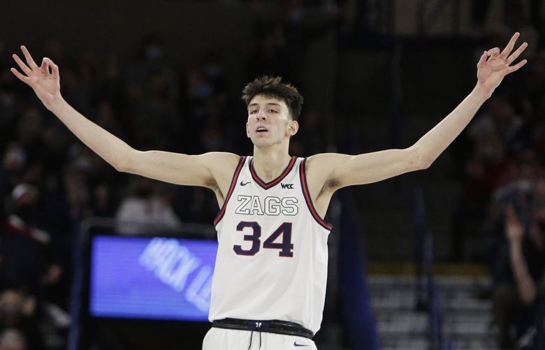 Gonzaga center Chet Holmgren celebrates a basket by guard Julian Strawther during the second half of the team’s NCAA college basketball game against Saint Mary’s, Saturday, Feb. 12, 2022, in Spokane, Wash. Gonzaga won 74-58. (AP Photo/Young Kwak)