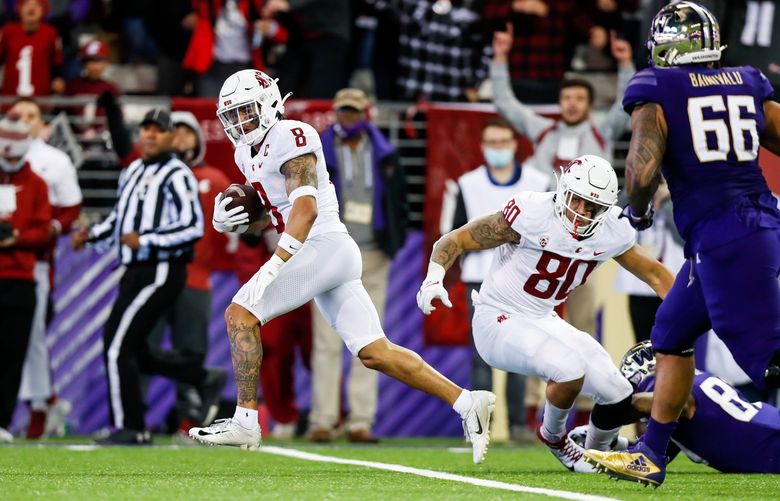 Husky Stadium – Apple Cup – University of Washington Huskies vs. Washington State University Cougars – 112621

Washington State Cougars defensive back Armani Marsh looks around as he returns an interception for a touchdown during the fourth quarter Friday, Nov. 26, 2021, in Seattle. 218907