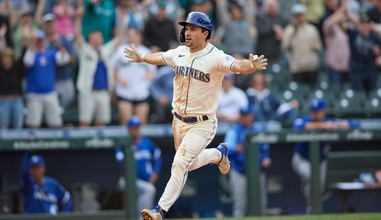 Seattle Mariners’ Adam Frazier scores the winning run in the 12th inning against the Kansas City Royals of a baseball game, Sunday, April 24, 2022, in Seattle. (AP Photo/John Froschauer)
