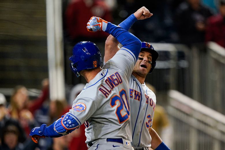 New York Mets' Pete Alonso celebrates in the dugout after hitting