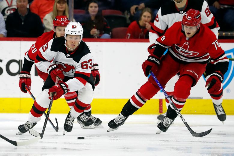 Carolina Hurricanes' Ethan Bear (25) skates with the puck during the first  period of an NHL