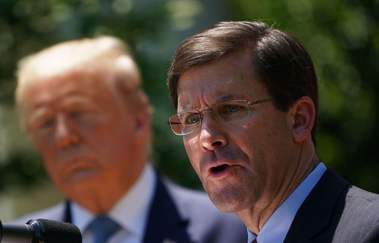U.S. Defense Secretary Mark Esper, with U.S. President Donald Trump, speaks on vaccine development on May 15, 2020, in the Rose Garden of the White House, in Washington, D.C. (Mandel Ngan/AFP/Getty Images/TNS) 46820188W 46820188W