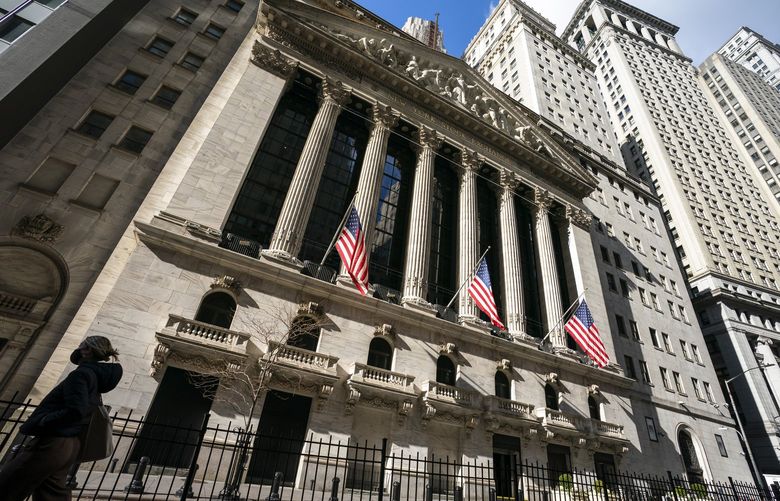 A pedestrian walks past the New York Stock Exchange, Jan. 24, 2022, in New York. (AP Photo/John Minchillo, File)