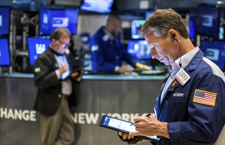 In this photo provided by the New York Stock Exchange, trader Robert Charmak, right, works on the floor, Monday May 2, 2022. The subdued start to May follows a dismal April, where Big Tech companies dragged the broader market lower as they started to look overpriced, particularly with interest rates set to rise sharply. (Courtney Crow/New York Stock Exchange via AP) NYRD102 NYRD102