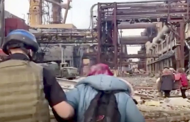 This frame taken from an undated video provided Sunday, May 1, 2022 by the Azov Special Forces Regiment of the Ukrainian National Guard shows people walking over debris at the Azovstal steel plant, in Mariupol, eastern Ukraine.  As many as 100,000 people may still be in Mariupol, including an estimated 2,000 Ukrainian fighters beneath the sprawling, Soviet-era steel plant â€” the only part of the city not occupied by the Russians. (Azov Special Forces Regiment of the Ukrainian National Guard via AP) LBL101 LBL101