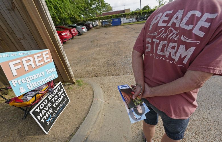 Longtime anti-abortion activist Barbara Beavers, waits by the entrance to the Jackson Women’s Health Organization (JWHO), Mississippi’s last remaining abortion clinic parking lot, to hand out pro-life materials to an incoming patients, Tuesday, May 3, 2022. (AP Photo/Rogelio V. Solis) MSRS104 MSRS104