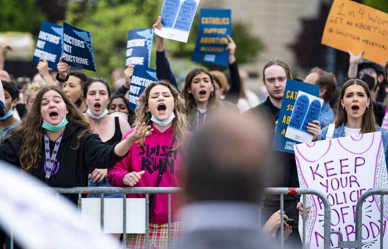 Advocates on both sides of the abortion divide demonstrate Tuesday. MUST CREDIT: Washington Post photo by Jabin Botsford.