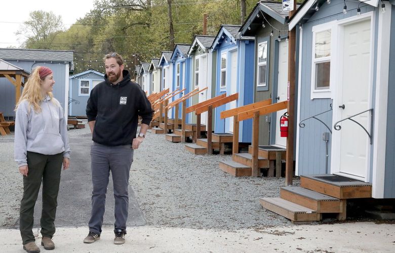 Staffers Hailey Hunt, left, Sr Village Operations Manager and Carson Spaulding, Village Organizer at the as yet unoccupied 40 unit Tiny Homes. They are all wired and ready to move in but so far red tape has prevented homeless occupants from moving in. 220201
