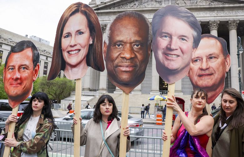 Members and supporters of Abortion Access Front carry cutouts of Supreme Court justices before a protest at Foley Square in Manhattan, May 3, 2022. The Supreme Court on Tuesday confirmed the authenticity of a leaked draft ruling overturning the Roe v. Wade decision establishing a constitutional right to abortion but stressed that it was not final even as the disclosure triggered a political earthquake with potentially broad electoral and legal consequences. From left: Cutouts of Chief Justice John Roberts and Justices Amy Coney Barrett, Clarence Thomas, Brett Kavanaugh and Samuel Alito. (Caitlin Ochs/The New York Times) XNYT223