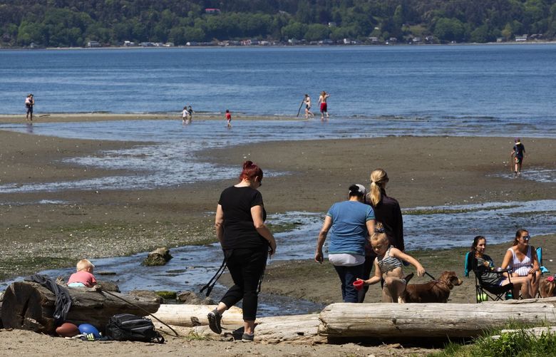 Visitors to Dash Point State Park in Federal Way walk on the beach on the first day the park has been reopened to the public, Tuesday, May 5, 2020.   213890
