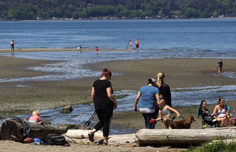 Visitors to Dash Point State Park in Federal Way walk on the beach on the first day the park has been reopened to the public, Tuesday, May 5, 2020. 213890