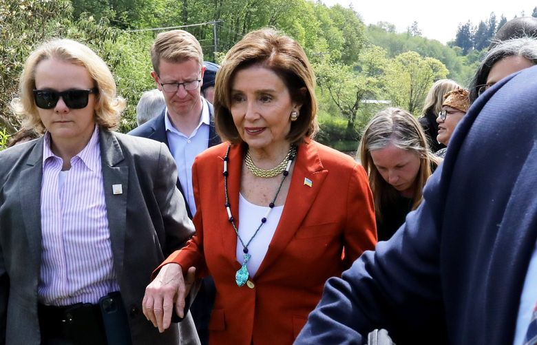 Speaker of the U.S. House of Representatives Nancy Pelosi, center in orange, is escorted a waiting vehicle after the press conference in Pierce County along Chambers Creek.  Security is ever-present for the speaker.

Wednesday May 4, 2022 220307
