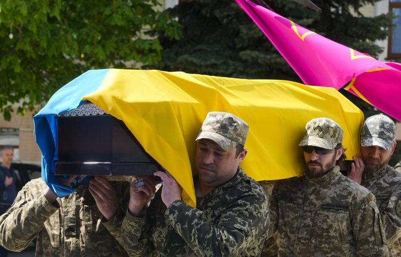 Ukrainian soldiers carry a coffin of soldier Ruslan Borovyk killed by the Russian troops in a battle for his funeral at St Michael cathedral in Kyiv, Ukraine, Wednesday, May 4, 2022.(AP Photo/Efrem Lukatsky) XEL105 XEL105