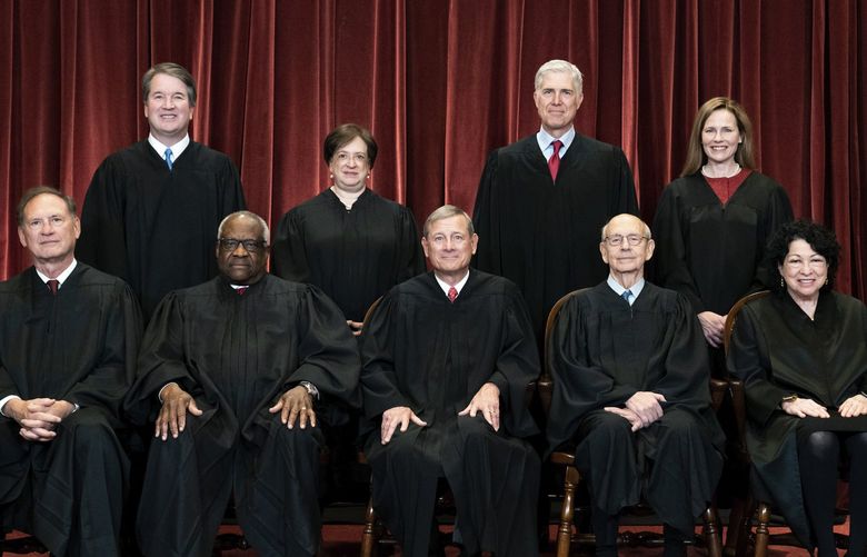 FILE – Members of the Supreme Court pose for a group photo at the Supreme Court in Washington, April 23, 2021. Seated from left are Associate Justice Samuel Alito, Associate Justice Clarence Thomas, Chief Justice John Roberts, Associate Justice Stephen Breyer and Associate Justice Sonia Sotomayor, Standing from left are Associate Justice Brett Kavanaugh, Associate Justice Elena Kagan, Associate Justice Neil Gorsuch and Associate Justice Amy Coney Barrett. (Erin Schaff/The New York Times via AP, Pool) NYNYT401 NYNYT401