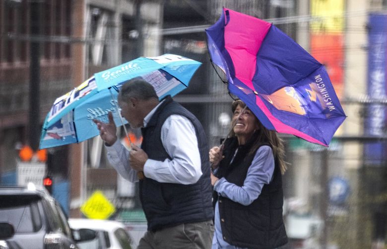 Thursday, May 5, 2022. Lines Only. LO. It’s rainy, it’s windy it’s both at once as this couple finds out crossing 2nd Ave. on Stewart Street in downtown Seattle. 220325