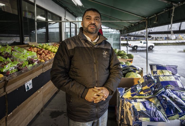 Manager Mohamed Elshabik stands outside JD’s Market, near the  future Sound Transit light-rail station. The market has to move to make way for development. Its new location nearby has to be renovated, and the staff has been wrangling with Sound Transit over reimbursements. (Steve Ringman / The Seattle Times)