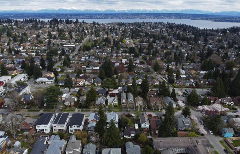 During Gov. Inslee’s stay-home order during the coronavirus, an eastward-looking view of Seattle homes with Lake Washington and the Cascade Mountains in the background are seen from above 32nd Ave. NE, between 65th and 62nd streets, Saturday, April 4, 2020 in Seattle. The view looks across Northeast Seattle toward View Ridge. 213566