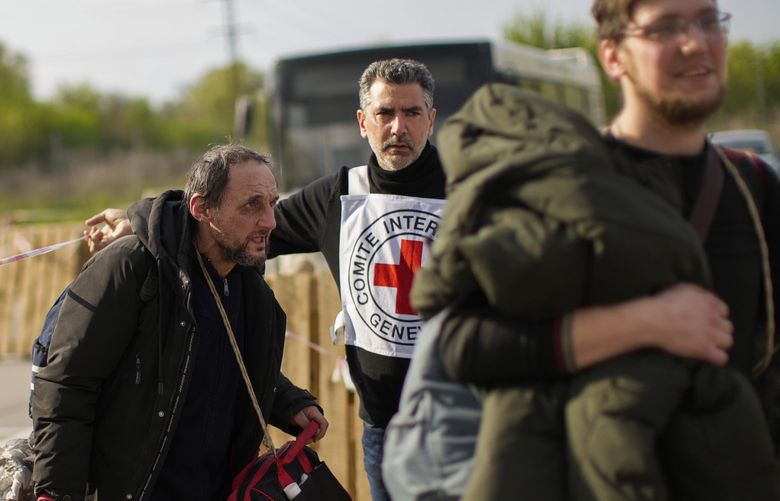 Serhii Tsybulchenko, left, and his son-in-law Ihor Trotsak, right, who fled with their family from the Azovstal steel plant in Mariupol, arrive to a reception center for displaced people in Zaporizhzhia, Ukraine, Tuesday, May 3, 2022. The Tsybulchenko family was among the first to emerge from the steel plant in a tense, days-long evacuation negotiated by the United Nations and the International Committee of the Red Cross with the governments of Russia, which now controls Mariupol, and Ukraine, which wants the city back. A brief cease-fire allowed more than 100 civilians to flee the plant. (AP Photo/Francisco Seco) NY622 NY622