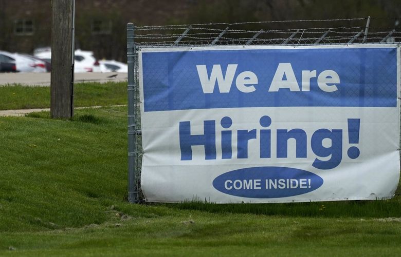 A hiring sign is displayed in Wheeling, Ill., Thursday, May 5, 2022.  Americaâ€™s employers added 428,000 jobs in April, extending a streak of solid hiring that has defied punishing inflation, chronic supply shortages, the Russian war against Ukraine and much higher borrowing costs.   (AP Photo/Nam Y. Huh) NYBZ511 NYBZ511