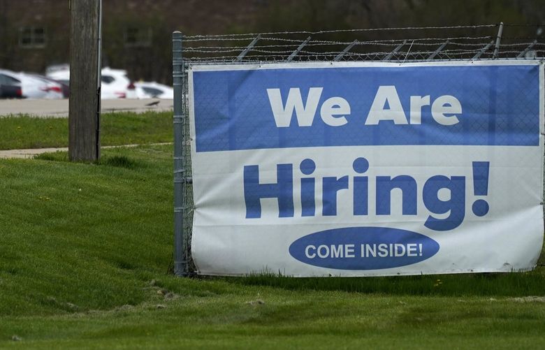 A hiring sign is displayed in Wheeling, Ill., Thursday, May 5, 2022. America’s employers added 428,000 jobs in April, extending a streak of solid hiring that has defied punishing inflation, chronic supply shortages, the Russian war against Ukraine and much higher borrowing costs. (AP Photo/Nam Y. Huh) NYBZ511 NYBZ511