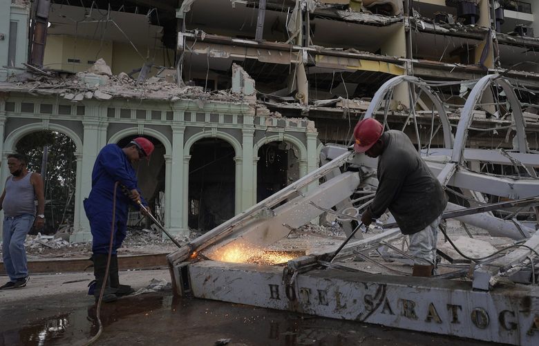 Workers remove debris from the site of Friday’s deadly explosion that destroyed the five-star Hotel Saratoga, in Havana, Cuba, Saturday, May 7, 2022. (AP Photo/Ramon Espinosa) HAV102 HAV102
