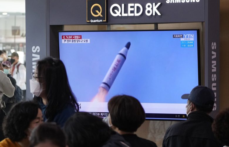 People watch a TV showing a file image of North Korea’s missile launch during a news program at the Seoul Railway Station in Seoul, South Korea, Saturday, May 7, 2022. North Korea fired a suspected ballistic missile designed to be launched from a submarine on Saturday, South Korea’s military said, apparently continuing a provocative streak in weapons demonstrations that may culminate with a nuclear test in the coming weeks or months. (AP Photo/Ahn Young-joon) SEL102 SEL102