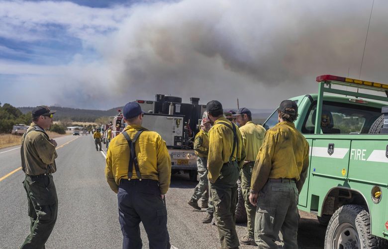 Wildland firefighters from several agencies throughout the country wait along state road 283 to be sent into the Hermits Peak and Calf Canyon Fires burning just west of Las Vegas, N.M. (Roberto E. Rosales/Albuquerque Journal) NMALJ101 NMALJ101
