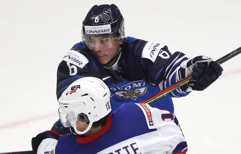 Finland’s goaltender Justus Annunen, left, watches as Alex Turcotte of the US, front, is checked by Finland’s Peetro Seppala, back, during the U20 Ice Hockey Worlds quarterfinal match between Finland and the United States in Trinec, Czech Republic, Thursday, Jan. 2, 2020. (AP Photo/Petr David Josek)