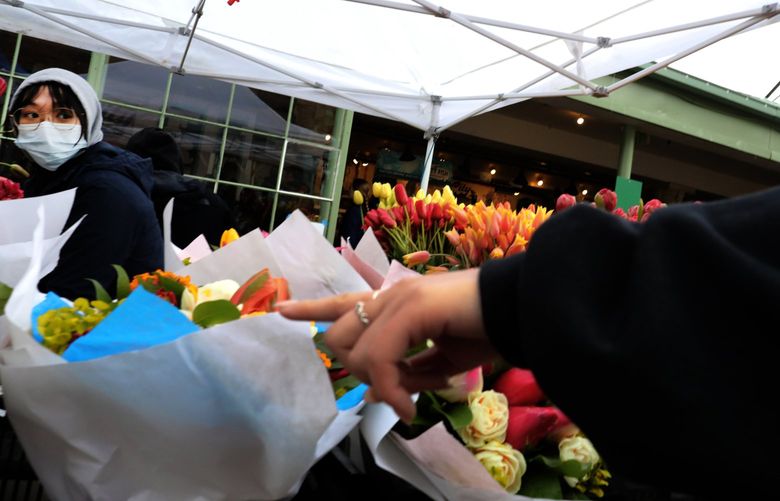 That bouquet is this shopper’s request at Jenny’s Garden stand during Mom’s Market Day at the Pike Place Market.
Kholy Xiong is among the staffers making flower arrangements.

During the 14th annual Flower Festival.  The flower festival continues Sunday.

Saturday May 7, 2022

LO Linesonly 220338