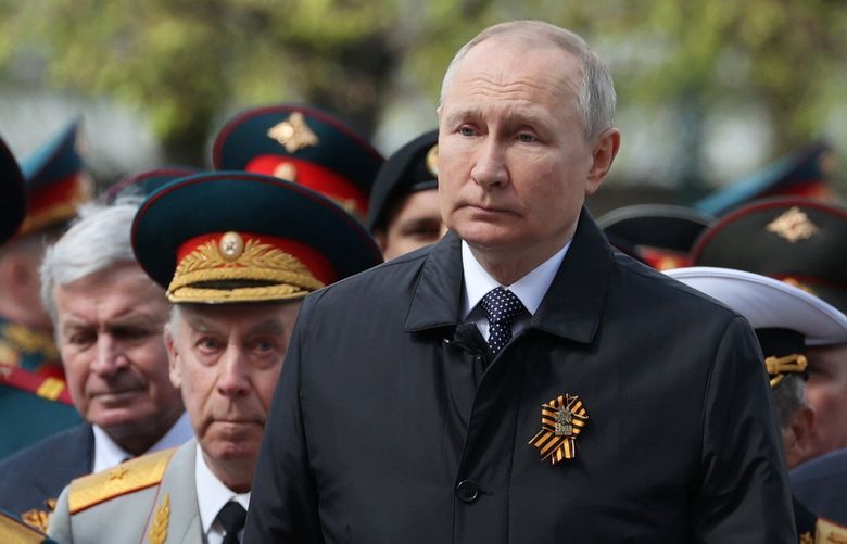 Russian President Vladimir Putin, centre, attends a wreath-laying ceremony at the Tomb of the Unknown Soldier after the military parade marking the 77th anniversary of the end of World War II, in Moscow, Russia, Monday, May 9, 2022. (Anton Novoderezhkin, Sputnik, Kremlin Pool Photo via AP) XSG154 XSG154