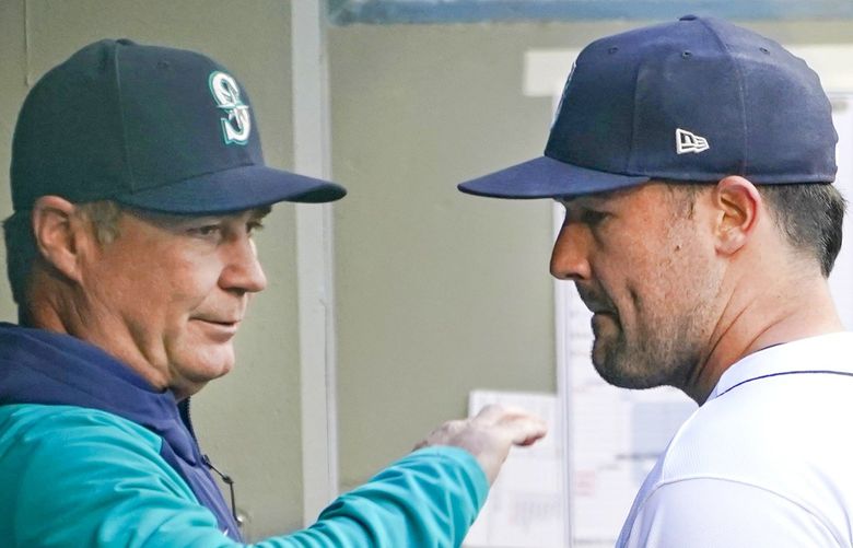 Seattle Mariners starting pitcher Robbie Ray, right, talks with manager Scott Servais in the dugout before the team’s baseball game against the Texas Rangers, Tuesday, April 19, 2022, in Seattle. (AP Photo/Ted S. Warren) WATW103