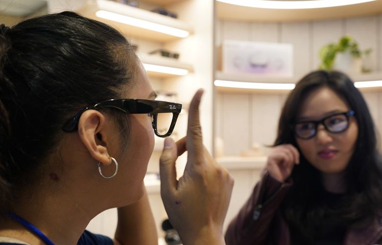 A Meta experience expert, left, demonstrates the Ray-Ban Stories smart glasses during a preview of the Meta Store in Burlingame, Calif., Wednesday, May 4, 2022. (AP Photo/Eric Risberg) FX403 FX403