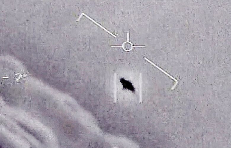 The image from video provided by the Department of Defense labelled Gimbal, from 2015, an unexplained object is seen at center as it is tracked as it soars high along the clouds, traveling against the wind. â€œThere’s a whole fleet of them,â€ one naval aviator tells another, though only one indistinct object is shown. â€œIt’s rotating.” The U.S. government has been taking a hard look at unidentified flying objects, under orders from Congress, and a report summarizing what officials know is expected to come out in June 2021. (Department of Defense via AP) DCJE1