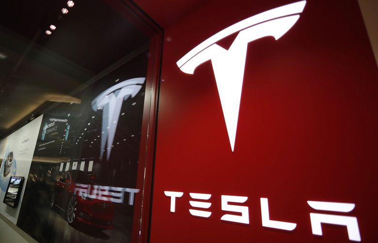 FILE – A sign bearing the company logo outside a Tesla store in Cherry Creek Mall in Denver, Feb. 9, 2019. Elon Musk has sold 4.4 million shares of  Tesla stock worth roughly $4 billion, most likely to help fund his purchase of Twitter. (AP Photo/David Zalubowski, File) TKMY101 TKMY101
