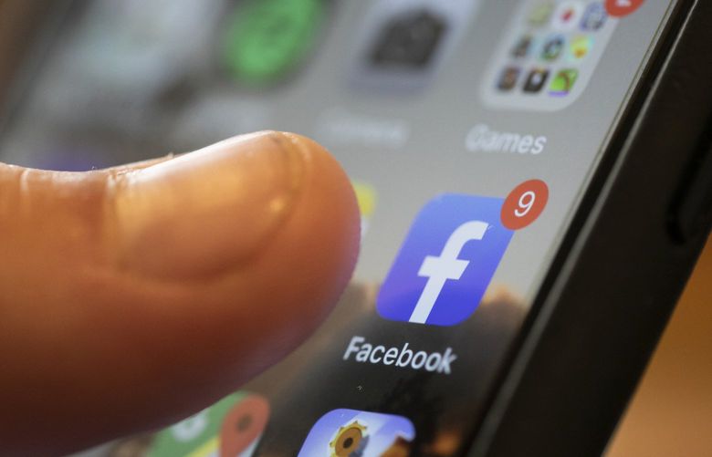 FILE – the Facebook app on a smartphone (AP Photo/Jenny Kane, File)