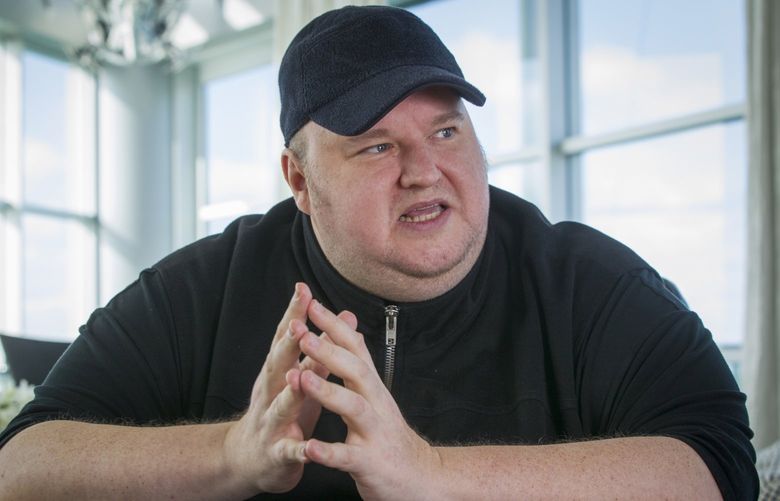 Megaupload founder Kim Dotcom gestures during an interview at his home in Auckland New Zealand, Dec. 21, 2015. Two men charged by U.S. prosecutors with racketeering for their involvement in the once wildly popular file-sharing website Megaupload said Tuesday, May 10, 2022, that they have reached a deal to avoid extradition to the U.S. and will instead face charges in New Zealand, where they live. Dotcom, who also lives in New Zealand, still faces the possibility of extradition to the U.S. in the long-running case. (Greg Bowker/New Zealand Herald via AP) NZH801 NZH801
