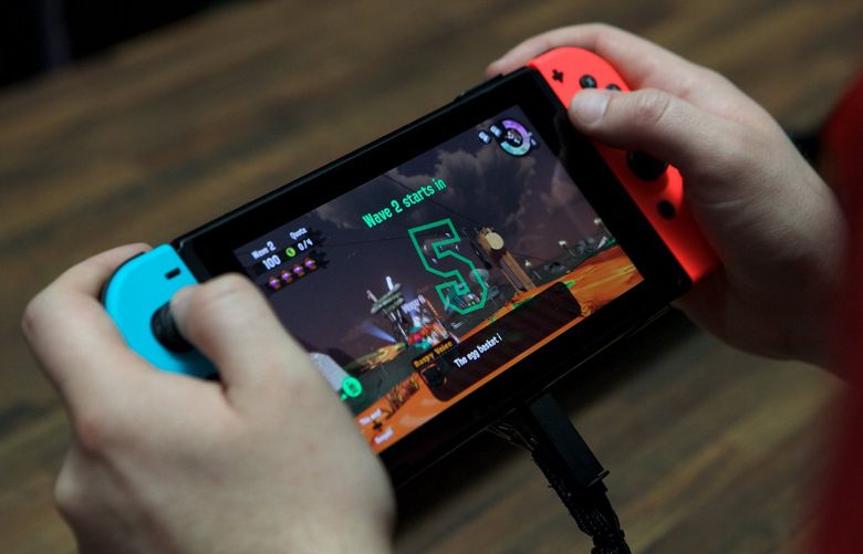 An attendee plays on a Nintendo Co. Switch video game console during the E3 Electronic Entertainment Expo in Los Angeles on June 14, 2017. (Troy Harvey/Bloomberg)