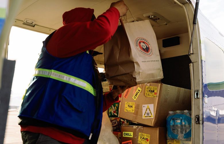 A fast-food takeout order on a plane with other cargo at Merrill Field in Anchorage, Alaska, April 21, 2022. With the help of bush pilots, residents of remote Alaskan villages can satisfy their cravings for city fare. (Kerry Tasker/The New York Times)
