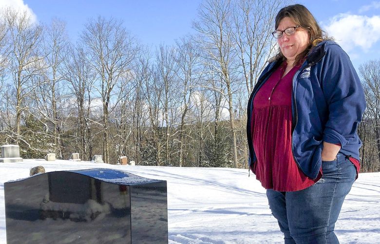 FILE – Deb Walker visits the grave of her daughter, Brooke Goodwin, Thursday, Dec. 9, 2021, in Chester, Vt. Goodwin, 23, died in March of 2021 of a fatal overdose of the powerful opioid fentanyl and xylazine, an animal tranquilizer that is making its way into the illicit drug supply. According to provisional data released by the Centers for Disease Control and Prevention on Wednesday, May 11, 2022, more than 107,000 Americans died of drug overdoses in 2021, setting another tragic record in the nation’s escalating overdose epidemic. (AP Photo/Lisa Rathke, File) RPLR501