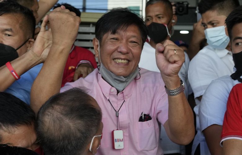 Presidential candidate Ferdinand “Bongbong” Marcos Jr. celebrates as he greets the crowd outside his headquarters in Mandaluyong, Philippines on Wednesday, May 11, 2022. Marcos’ apparent landslide victory in the Philippine presidential election is raising immediate concerns about a further erosion of democracy in Asia and could complicate American efforts to blunt growing Chinese influence and power in the Pacific. (AP Photo/Aaron Favila) XAF122 XAF122