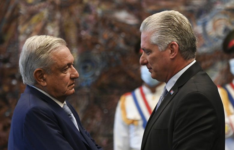 Cuban president Miguel Diaz Canel, right, shakes hands with his Mexican counterpart Andres Manuel Lopez Obrador at Revolution Palace in Havana, Cuba, Sunday, May 8, 2022. (Yamil Lage/Pool Photo via AP) XRE111 XRE111