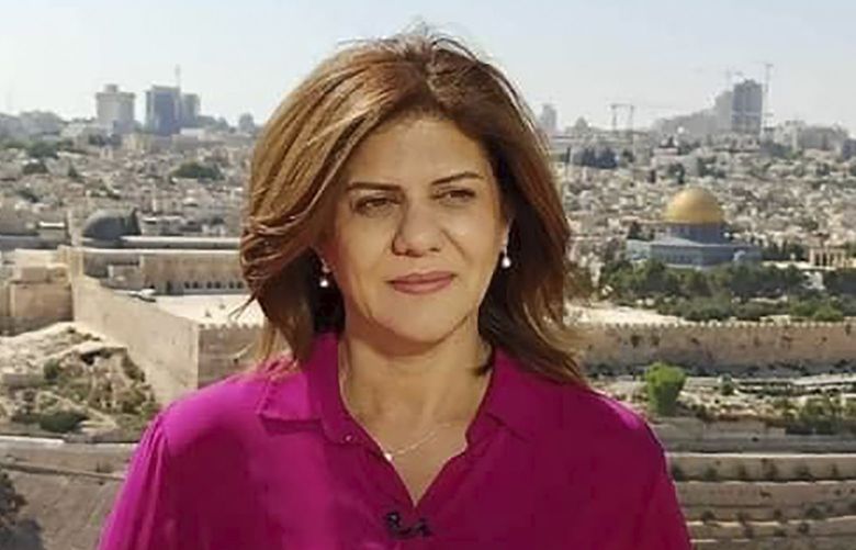 In this undated photo provided by Al Jazeera Media Network, Shireen Abu Akleh, a journalist for Al Jazeera network, stands in an area where the Dome of the Rock shrine at Al-Aqsa Mosque in the Old City of Jerusalem is seen at right in the background. Abu Akleh, a well-known Palestinian female reporter for the broadcaster’s Arabic language channel, was shot and killed while covering an Israeli raid in the occupied West Bank town of Jenin early Wednesday, May 11, 2022. (Al Jazeera Media Network via AP) TKHK302 TKHK302