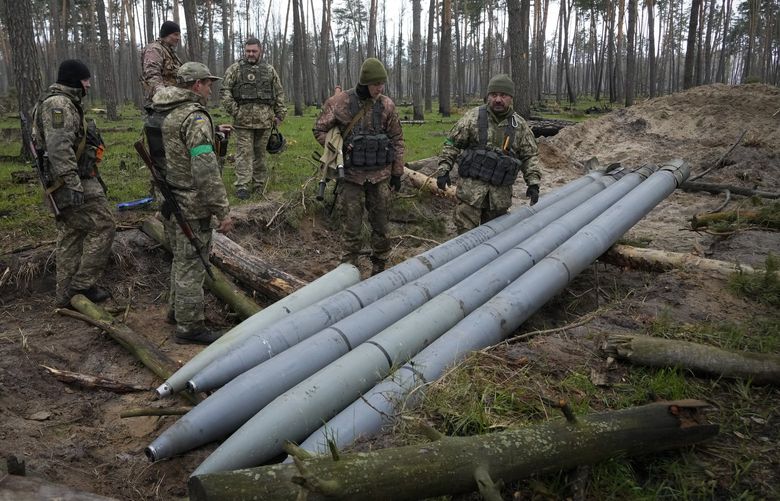 FILE – Ukrainian soldiers examine Russian multiple missiles abandoned by Russian troops, in the village of Berezivka, Ukraine, April 21, 2022. An interminable and unwinnable war in Europe? That’s what NATO leaders fear and are bracing for as Russia’s war in Ukraine grinds into its third month with little sign of a decisive military victory for either side, and no resolution in sight. (AP Photo/Efrem Lukatsky, File) WX208 WX208