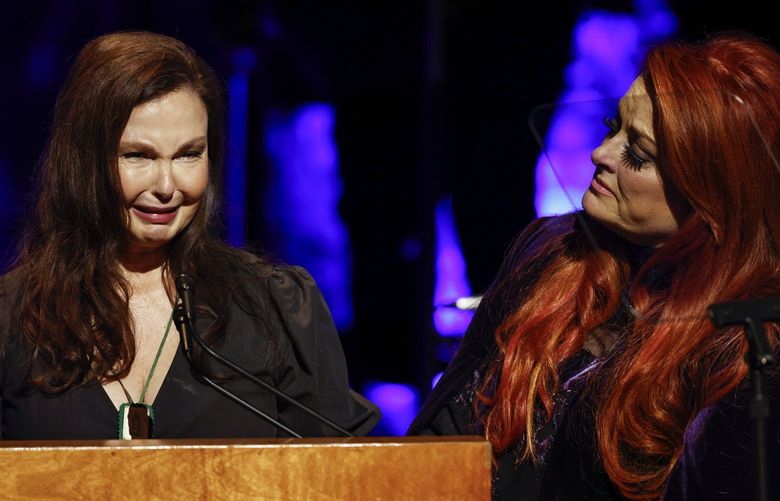 Ashley Judd, left, cries as she speaks as sister Wynonna Judd watches during the Medallion Ceremony at the Country Music Hall of Fame Sunday, May 1, 2022, in Nashville, Tenn. (Photo by Wade Payne/Invision/AP) CAJS128 CAJS128